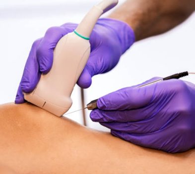 Physiotherapist giving knee therapy to a woman in clinic. Physical treatment concept